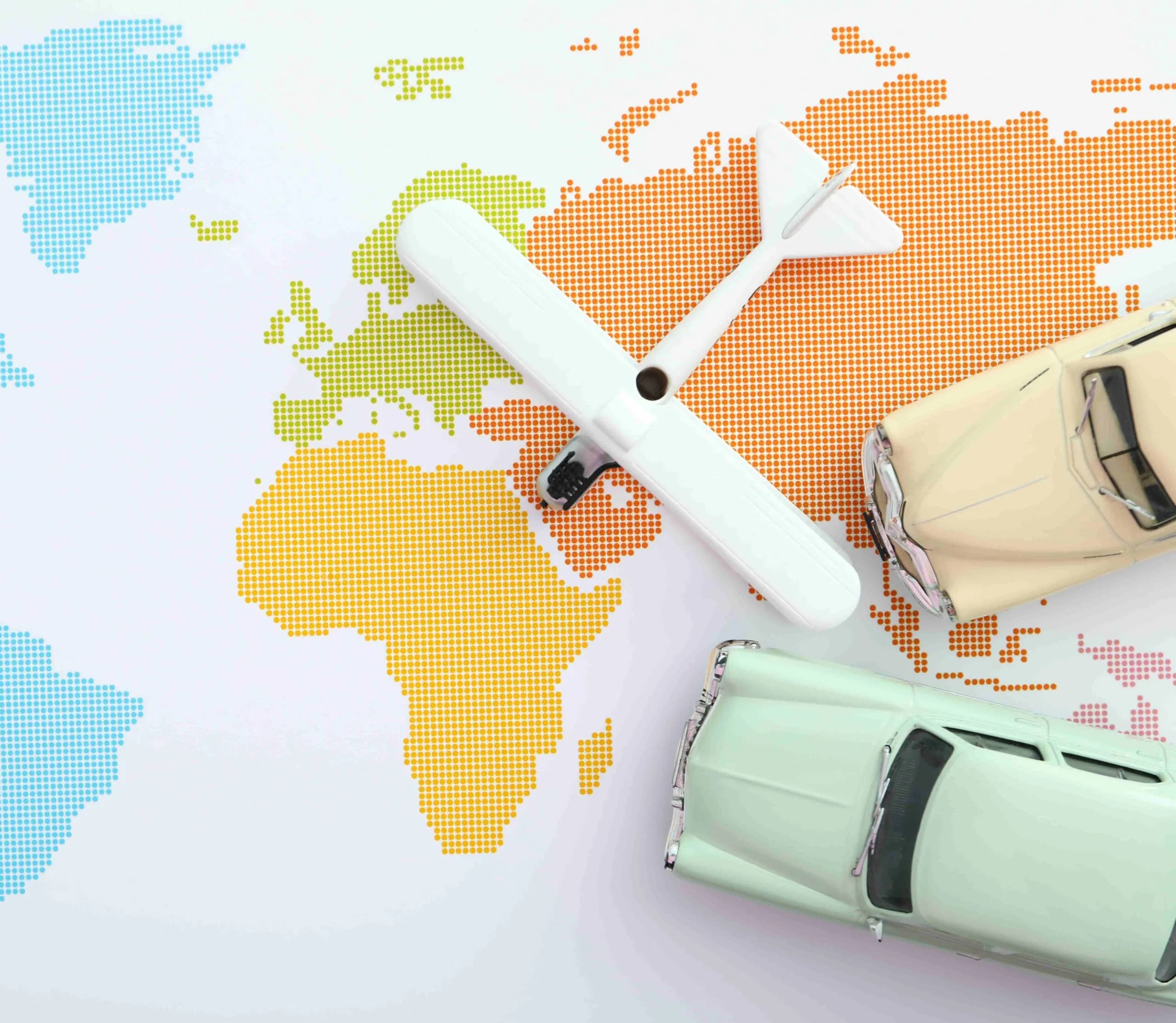 A world map with a toy plane and car representing global travel