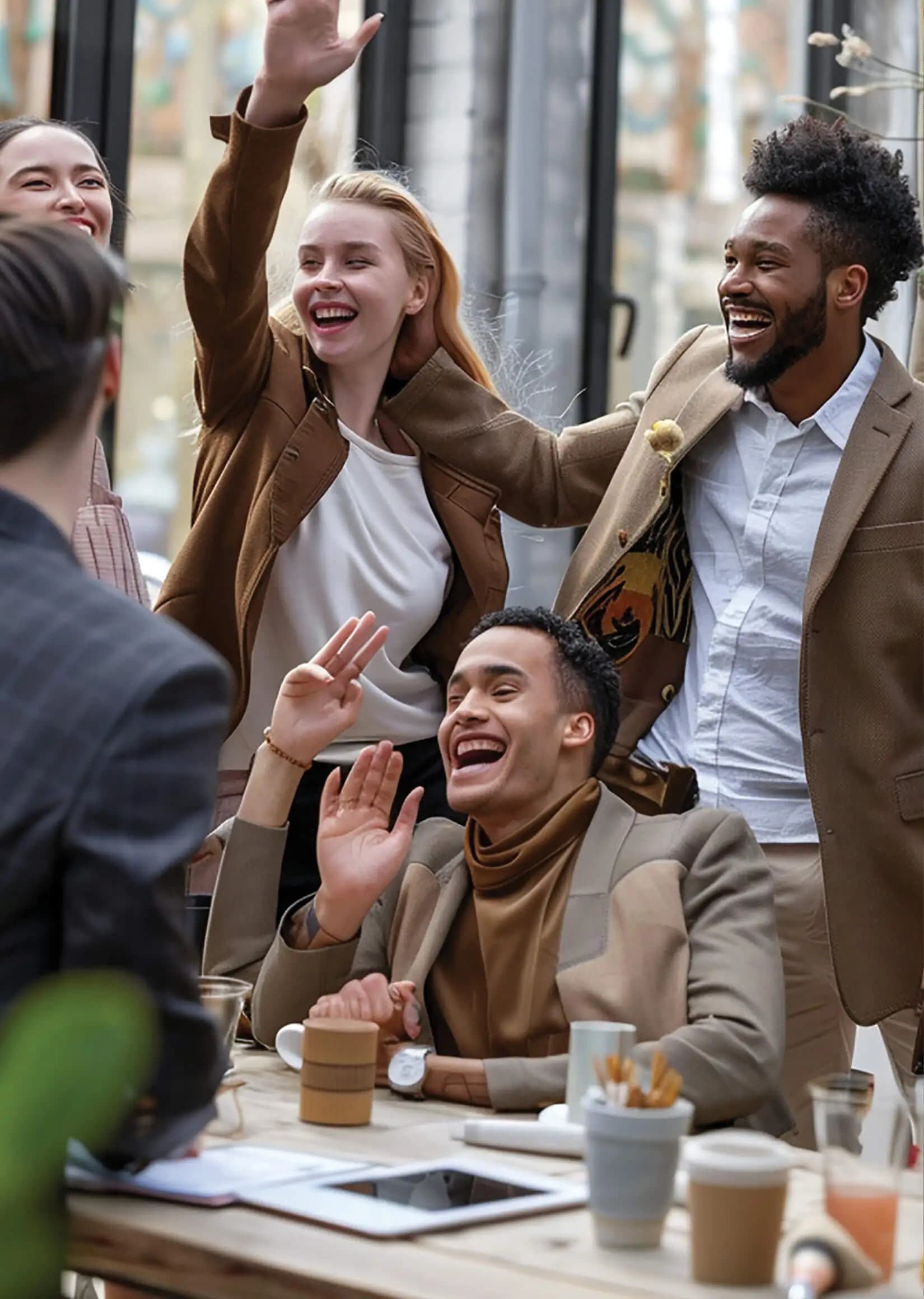 A group of friends laughing and celebrating together